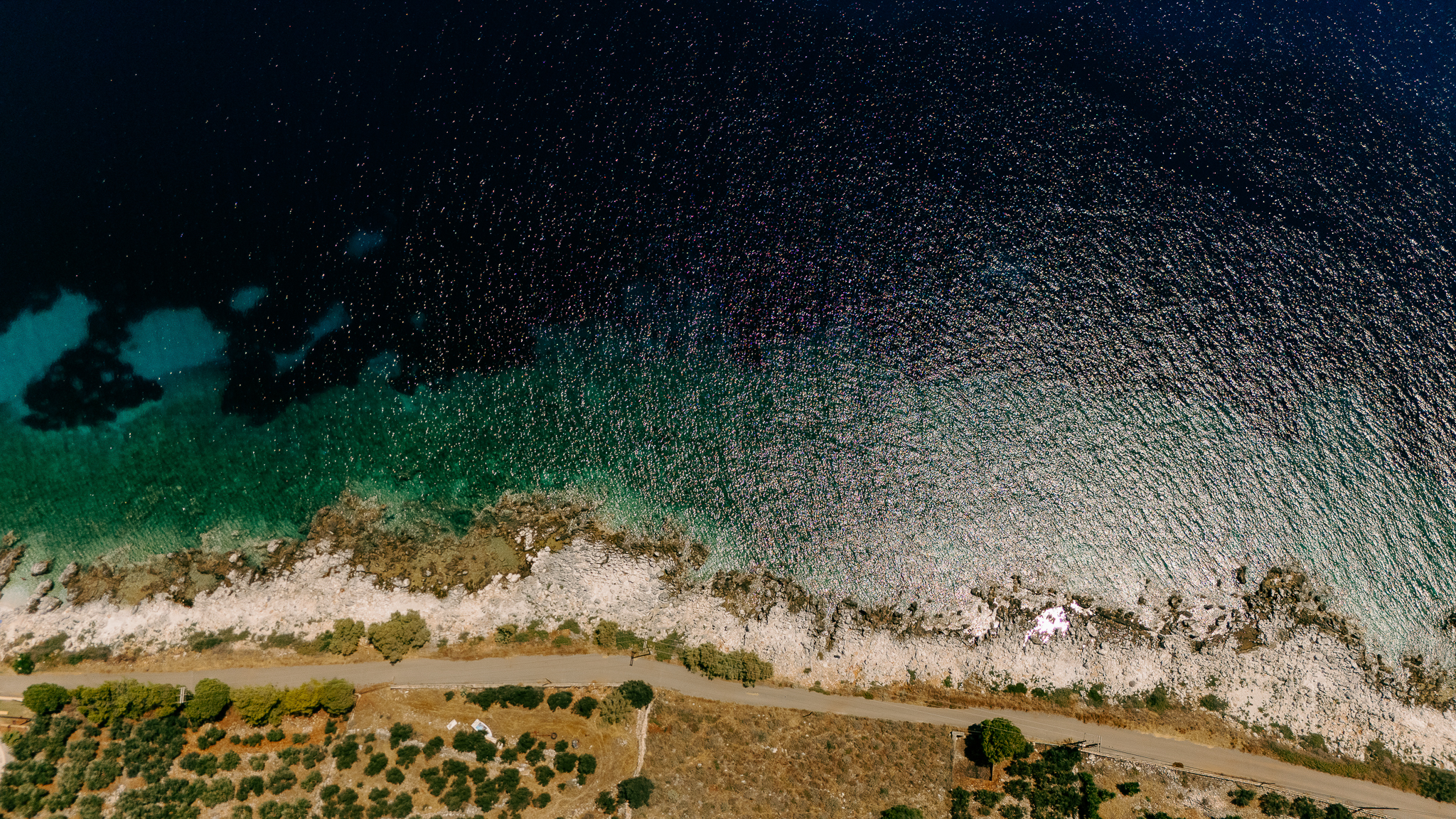 Clear coastal waters and stone village in Mani